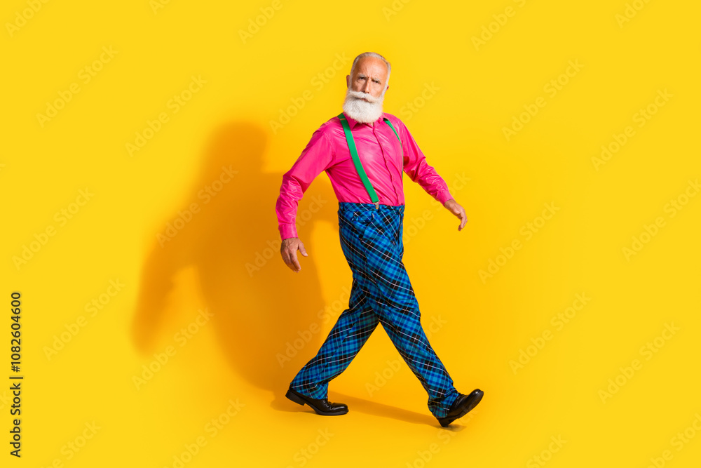 Full size photo of old gentleman walking step dressed glamour stylish outfit party isolated vibrant yellow color background Full size photo of old gentleman walking step dressed glamour stylish outfit party isolated vibrant yellow color background