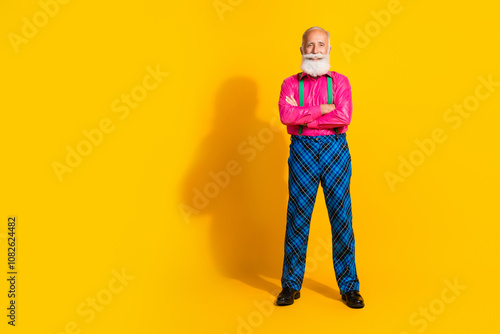 Full size photo of handsome pensioner mister crossed hands wear pink shirt retro plaid pants classy garment isolated on yellow background