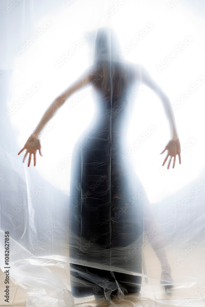 Mysterious Woman Behind Frosted Plastic Sheet in Abstract Studio Setting Mysterious Woman Behind Frosted Plastic Sheet in Abstract Studio Setting