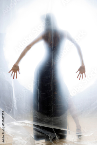 Mysterious Woman Behind Frosted Plastic Sheet in Abstract Studio Setting