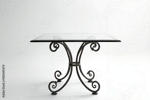 A glass table with a wrought iron base and a glass top photo