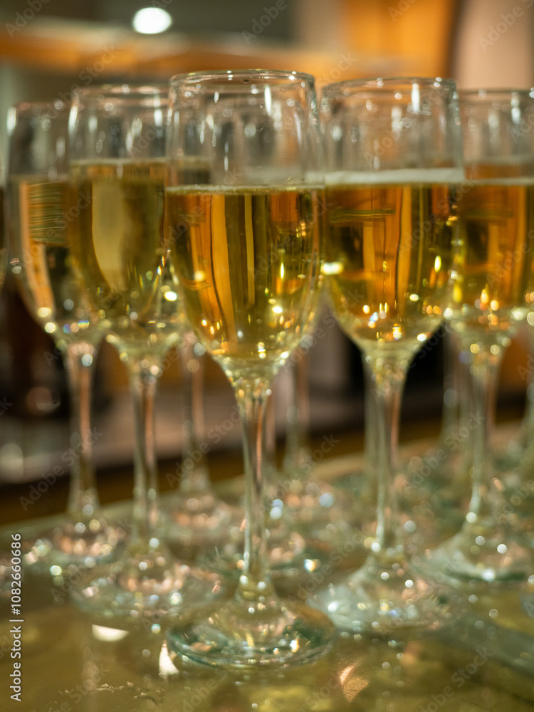 Champagne glasses filled and ready for a banquet, elegant setting, festive atmosphere Champagne glasses filled and ready for a banquet, elegant setting, festive atmosphere