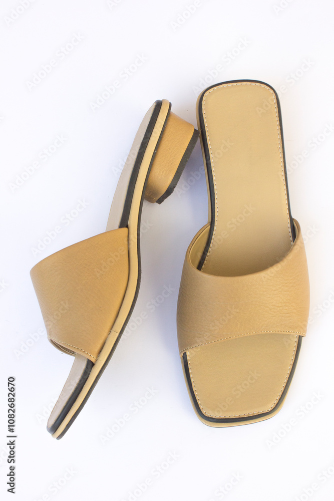 A brown women's open-toed sandal. These sandals are made of synthetic leather. A brown women's open-toed sandal. These sandals are made of synthetic leather.