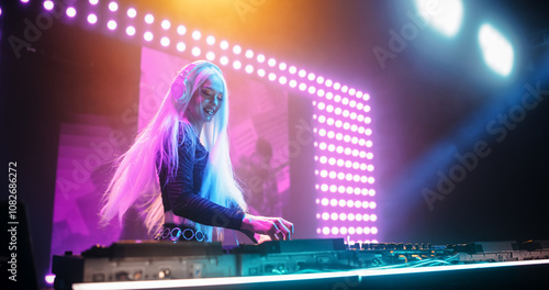 Fotografie Talented Female Artist Performing a DJ Set on Turntables Live on Stage