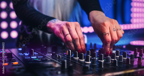 Fotografie Female DJ Performing Live on Stage, Mixing Tracks With Professional Equipment
