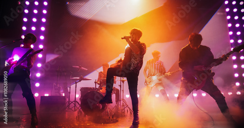 Obraz na plátně Energetic Rock Band Performing on a Nightclub Stage with Dynamic Lights, Animated LED Screen and Special Effects
