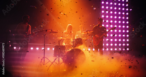 Fotografie Charismatic Drummer Girl Playing Drums at a Live Band Performance Under Falling Confetti