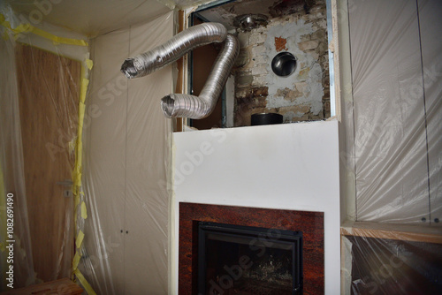 Obraz na płótnie Fireplace insert and chimney for wood heating and its repair w salonie
