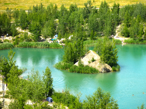 picturesque summer lake surrounded by birches and rocks with blue water in Konduki, Russia photo