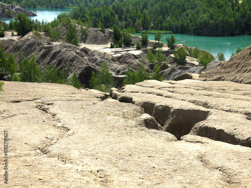 rocks with rare trees and crystal blue water in the Konduki quarry, Tula region, Russia