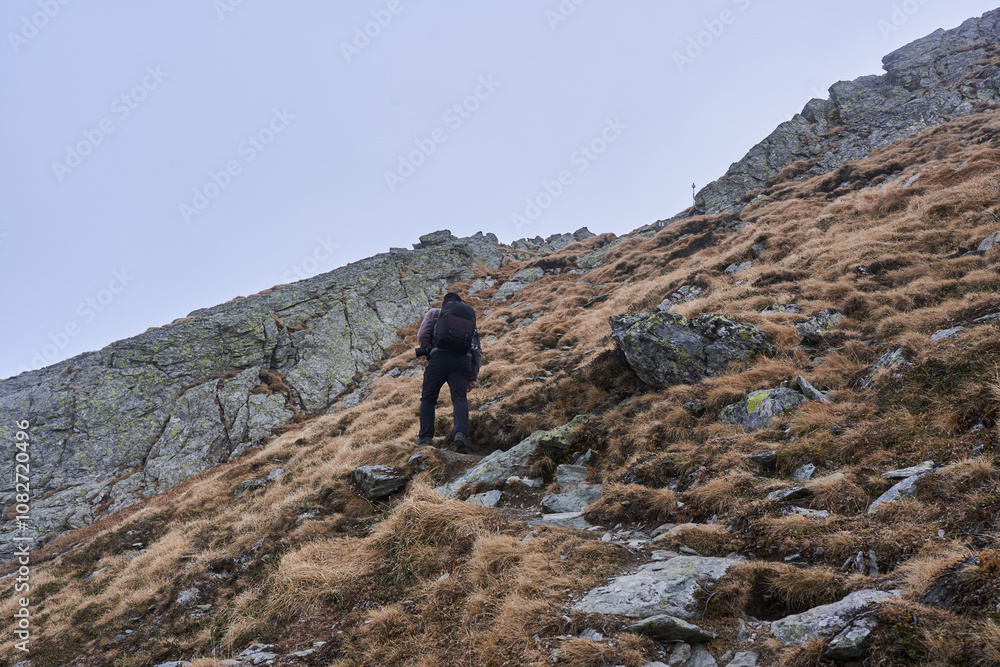 Man hiking in a cold day in the rocky mountains Man hiking in a cold day in the rocky mountains