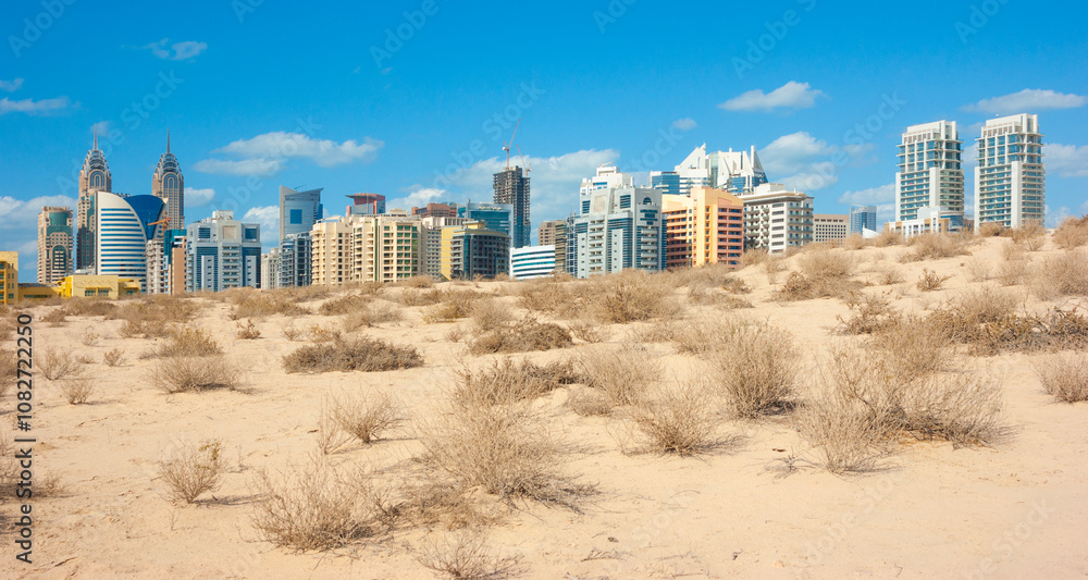 Midday heat in the desert in the background buildingsl on Nov 17, 2012 in Dubai UAE Midday heat in the desert in the background buildingsl on Nov 17, 2012 in Dubai UAE