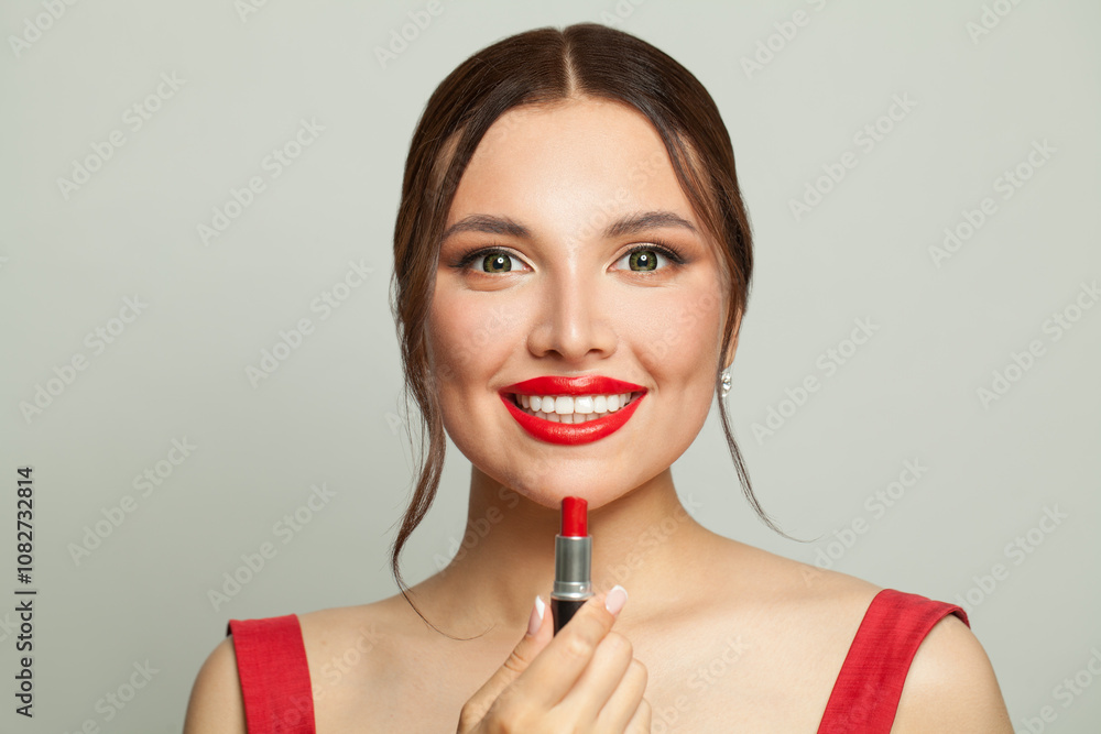 Attractive woman applying red lipstick on white background, beautiful face close-up Attractive woman applying red lipstick on white background, beautiful face close-up