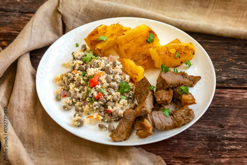 Traditional rustic tropical Brazilian dish, sun-dried beef with green beans, cassava, biquinho pepper. Creative rustic photography photo