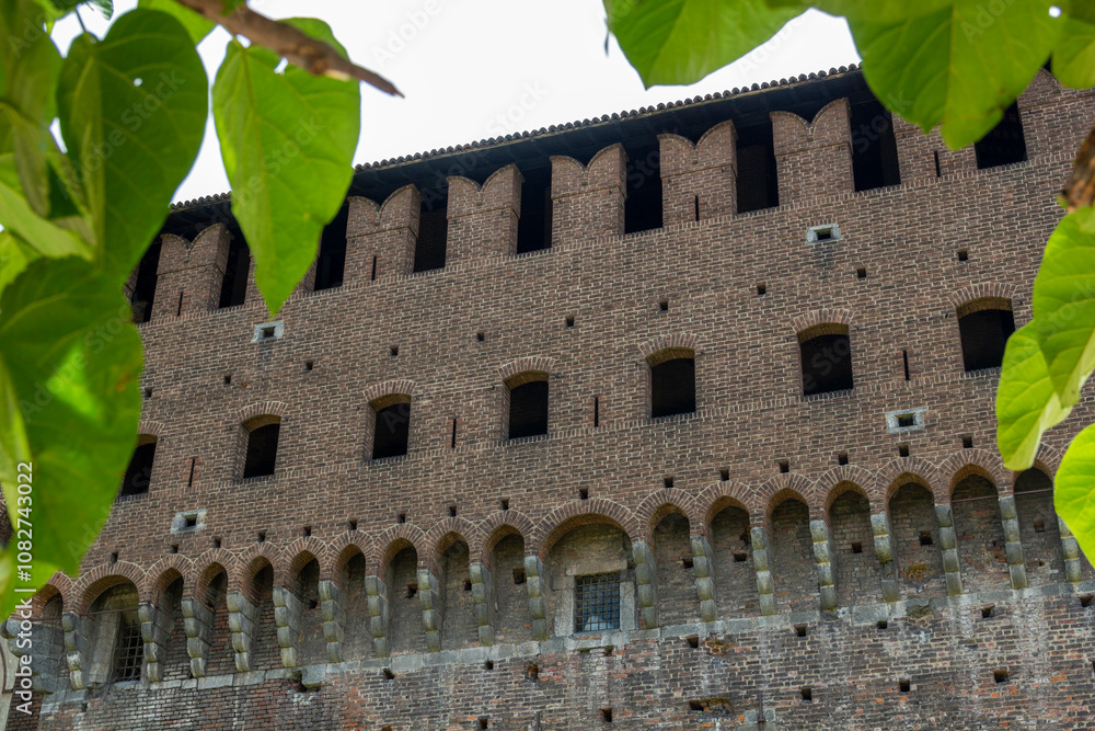 Obraz premium the famous historic castle castello sforzesco in Milan, Italy. At a sunny summer day with green park area 