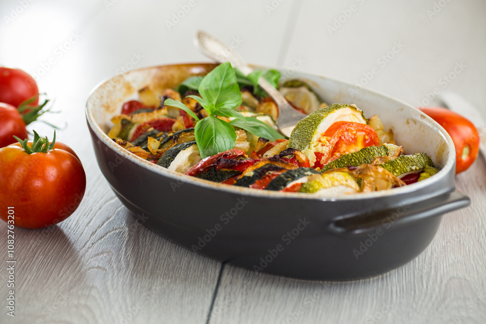prepared baked zucchini and tomatoes in circles in a ceramic form, vegetable snack prepared baked zucchini and tomatoes in circles in a ceramic form, vegetable snack