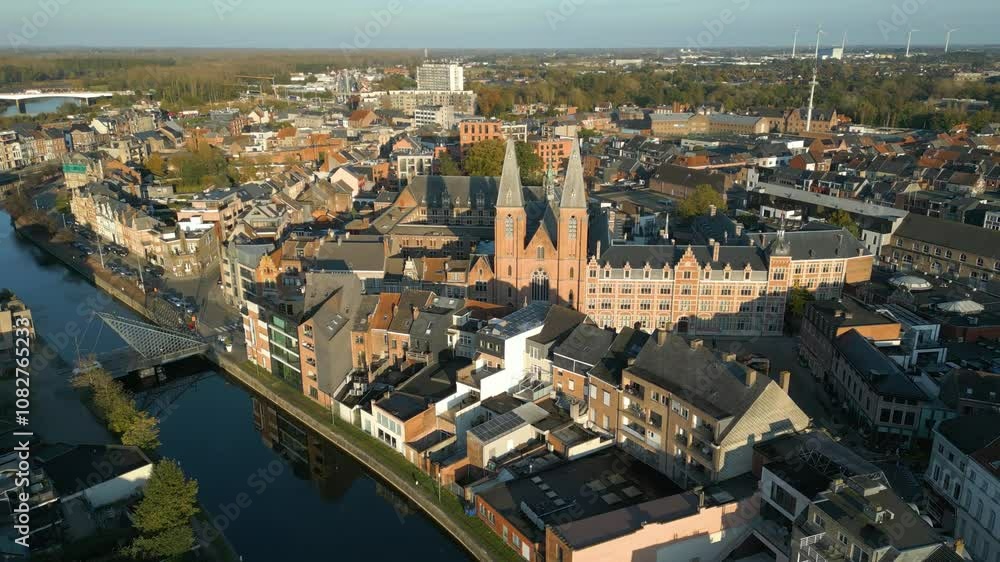 benedictine abbey dendermonde architecture along surrounding river canals evening golden hour light casts circling aerial drone shot view footage 