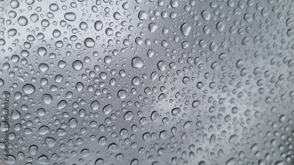 Raindrops on glass close-up. Black and white monochrome. Selective focus Raindrops on glass close-up. Black and white monochrome. Selective focus