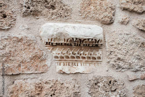 Antalya, Turkiye - September, 30, 2024: Ancient Carved Stone Detail in the wall of an old turkish house, Kaleichi - Antalya Old town. photo