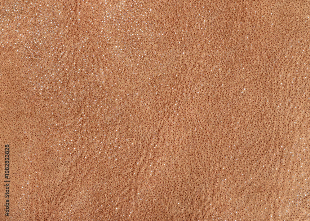 Texture of tanned leather in brown color with glitter. Texture of tanned leather in brown color with glitter.