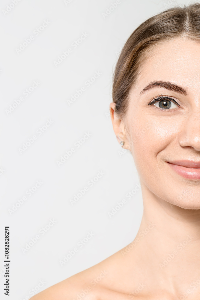 Beautiful young woman after henna eyebrows dyeing on light background, closeup Beautiful young woman after henna eyebrows dyeing on light background, closeup