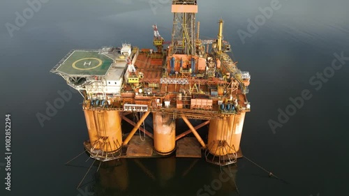 offshore oil rig drilling platform parked estuary role energy production engineering environmental aspects circling aerial footage operational orders marine infrastructure 