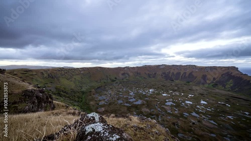 Sunrise illuminates the rano kau volcano crater on easter island, showcasing the breathtaking beauty of chile's landscape