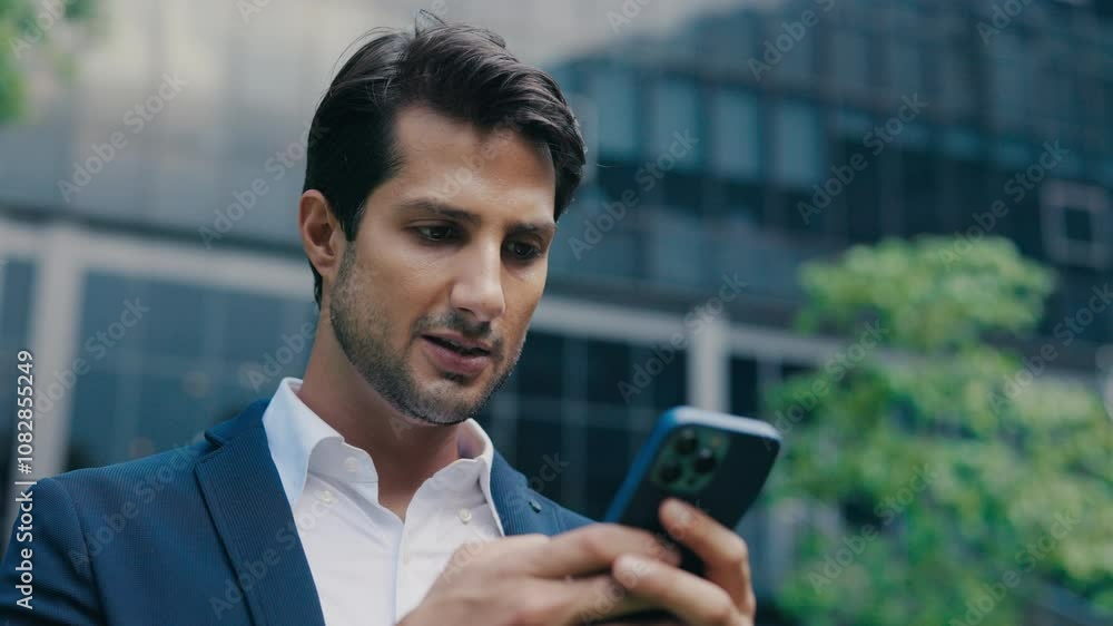 Overjoyed Stylish Boss in Formal Suit Winner Celebrating Victory Success on Smartphone Outside near the Office. Overjoyed Stylish Boss in Formal Suit Winner Celebrating Victory Success on Smartphone Outside near the Office.