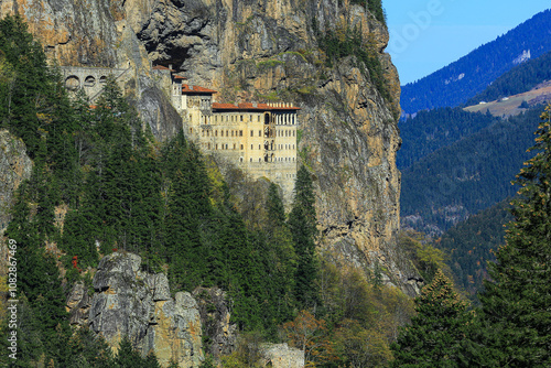 Фотография Image of the monastery built into the rocks on the mountainside.