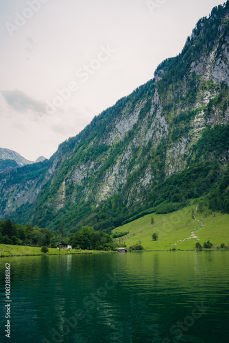 Konigssee Lake in Bavaria Germany with Church by the Lake White Boat Forested Mountain and Beautiful Sunny Trekking in Berchtesgaden German Alps. High quality photo