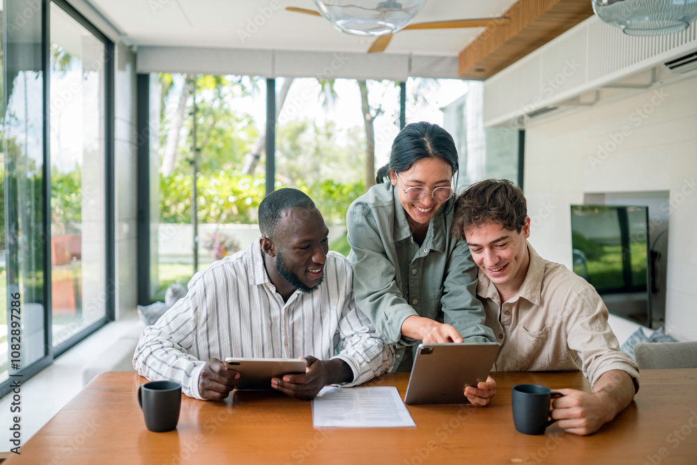 A group of diverse young adults collaborates over a digital tablet in a bright, contemporary office space, dressed in casual professional attire, surrounded by modern furnishings and natural light. A group of diverse young adults collaborates over a digital tablet in a bright, contemporary office space, dressed in casual professional attire, surrounded by modern furnishings and natural light.