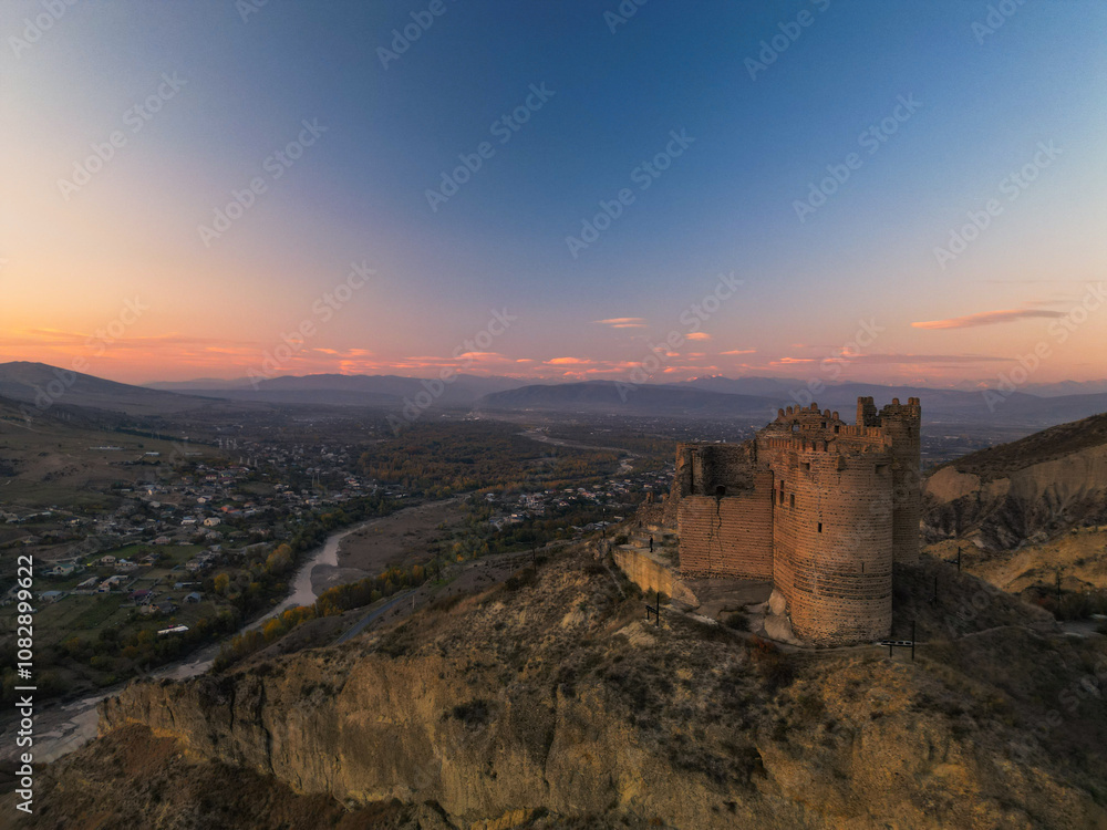 Fantasy breathtaking castle on top of mountain at sunset in Georgia Ksani Fantasy breathtaking castle on top of mountain at sunset in Georgia Ksani
