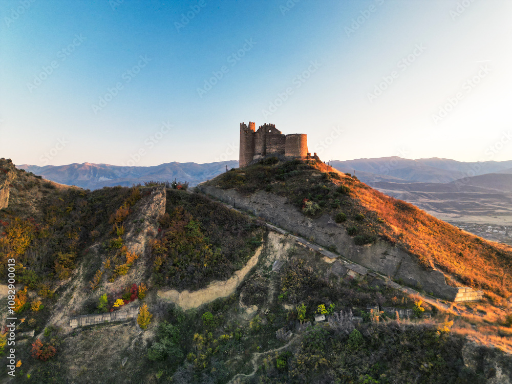 Fantasy breathtaking castle on top of mountain at sunset in Georgia Ksani Fantasy breathtaking castle on top of mountain at sunset in Georgia Ksani