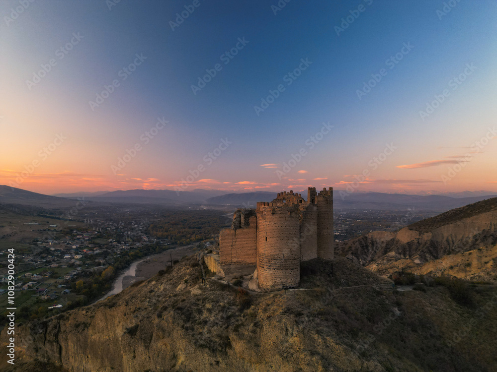 Fantasy breathtaking castle on top of mountain at sunset in Georgia Ksani Fantasy breathtaking castle on top of mountain at sunset in Georgia Ksani