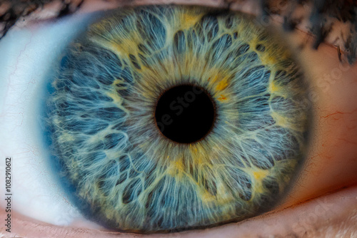 Macro close-up of a human eye with a stunning texture, featuring a blend of yellow and blue hues, showcasing intricate details and vibrant colors...