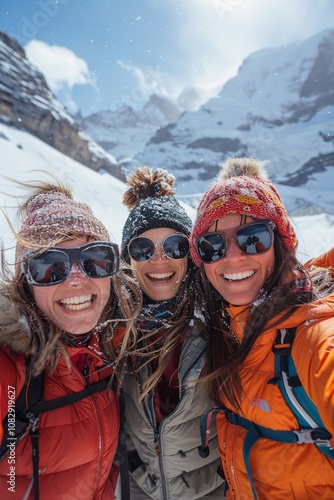 Three friends pose together in the snowy mountains, smiling widely while dressed in winter attire. The bright sun shines above, creating a cheerful atmosphere during their outdoor adventure