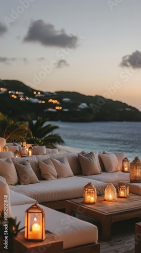 Cozy seaside lounge area with candles overlooking the ocean at sunset