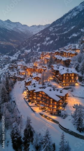 Snow covered village illuminated at dusk in the Swiss Alps