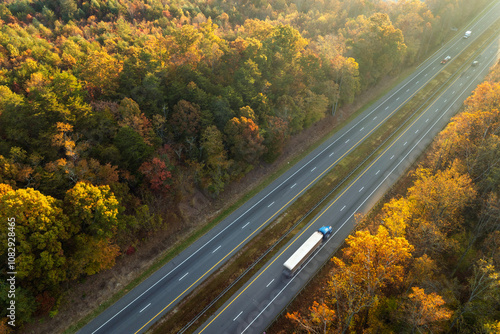 USA highway transportation infrastructure in North Carolina Appalachian mountains. American freeway road with fast driving semi trucks