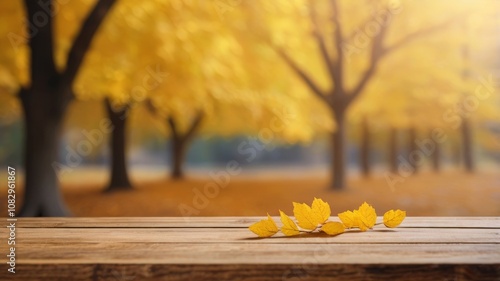 Obraz na płótnie Beautiful colorful natural autumn background for presentation. Fallen dry orange leaves on wooden boards against the backdrop of a blurry autumn park. w salonie