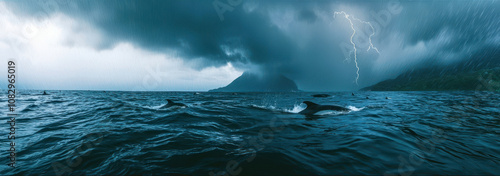 A stormy ocean with a few dolphins swimming in the water