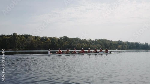 Wallpaper Mural Rowing team training. Side view of 8 young caucasian male rowers, during a rowing practice, athlete sitting in a boat in the river Dnipro, rows through a calm water in autumn. 4k footage. City area in Torontodigital.ca