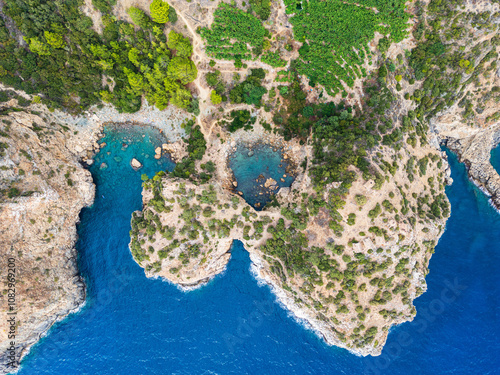 Aerial View of Rugged Coastline and Azure Waters.. photo