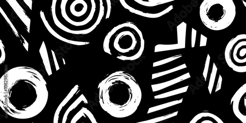 An abstract black and white pattern featuring various circles, stripes, and shapes, perfect for backgrounds or creative designs..