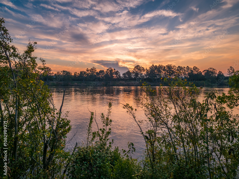 Naklejka premium Sunset Over The River