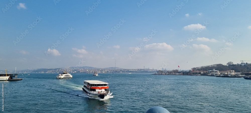 Obraz premium A view of the Bosporus Strait, where numerous ships and boats gently cross the water, connecting Europe and Asia