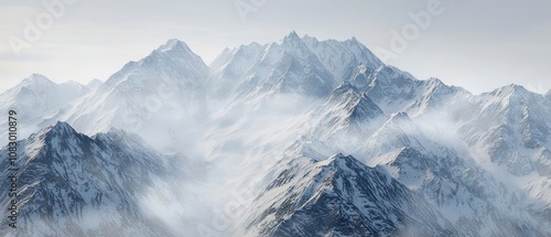 Snow-covered mountain peaks under a clear sky photo