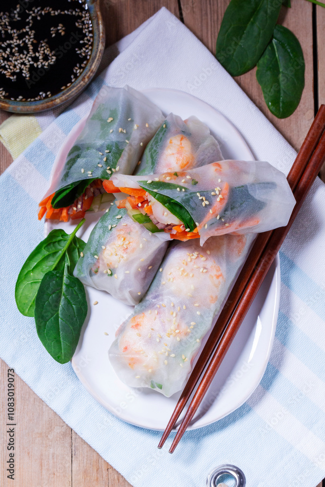 Summer or spring rolls with shrimp, vegetables and spinach, served with soy sauce and sesame. Traditional Vietnamese food.