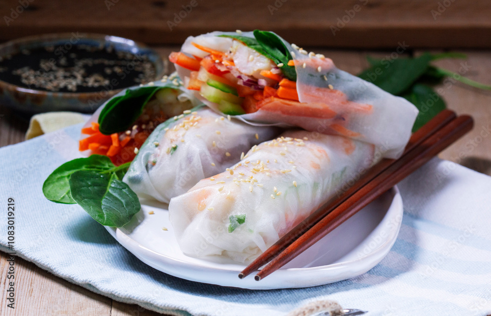 Summer or spring rolls with shrimp, vegetables and spinach, served with soy sauce and sesame. Traditional Vietnamese food.