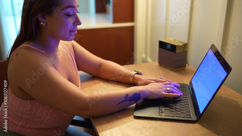 Beautiful latin woman typing on keyboard laptop sitting at desk